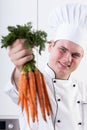 Smiling cook with carrots