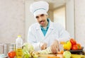 Smiling cook does vegetarian lunch Royalty Free Stock Photo