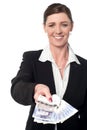 Smiling corporate woman showing british pound