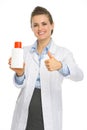 Smiling cosmetologist with bottle of sunscreen Royalty Free Stock Photo