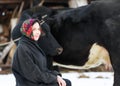 Smiling country girl with a cow