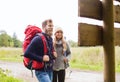 Smiling couple with backpacks hiking