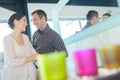 Smiling couple behind row coloured candles Royalty Free Stock Photo