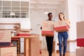 Smiling Couple Carrying Boxes Into New Home On Moving Day Royalty Free Stock Photo