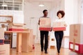 Smiling Couple Carrying Boxes Into New Home On Moving Day Royalty Free Stock Photo