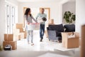 Smiling Couple Carrying Boxes Into New Home On Moving Day Royalty Free Stock Photo