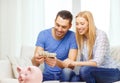 Smiling couple counting money at home