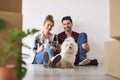 Smiling couple and dog in their new home Royalty Free Stock Photo