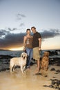 Smiling Couple With Dogs at the Beach Royalty Free Stock Photo