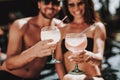 Smiling Couple Drinking Cocktails at Poolside Royalty Free Stock Photo