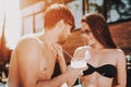 Smiling Couple Drinking Cocktails at Poolside Royalty Free Stock Photo