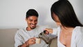 Smiling couple drinking coffee at sofa together closeup. Newlyweds taking break