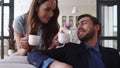 Smiling couple drinking tea at home together. Joyful couple taking coffee break Royalty Free Stock Photo