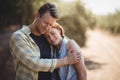 Smiling couple embracing on field at olive farm Royalty Free Stock Photo