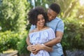 Smiling couple embracing in park on sunny day Royalty Free Stock Photo