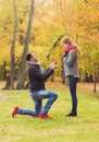 Smiling couple with engagement ring in gift box Royalty Free Stock Photo