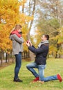 Smiling couple with engagement ring in gift box Royalty Free Stock Photo