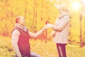 Smiling couple with engagement ring in gift box Royalty Free Stock Photo