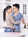 Smiling couple enjoying red vine in the kitchev Royalty Free Stock Photo