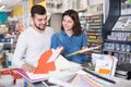 Couple examining various decorative materials Royalty Free Stock Photo