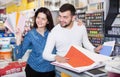 Couple examining various decorative materials Royalty Free Stock Photo