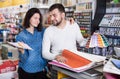 Couple examining various decorative materials Royalty Free Stock Photo