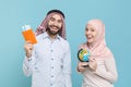 Smiling couple friends arabian muslim man wonam in keffiyeh kafiya ring igal agal hijab clothes isolated on blue