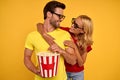 Smiling couple friends guy girl in 3d glasses isolated on yellow background. People in cinema lifestyle concept. Watching movie