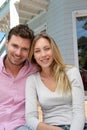 Smiling couple in front of their home Royalty Free Stock Photo