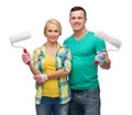 Smiling couple in gloves with paint rollers Royalty Free Stock Photo