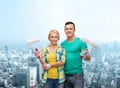 Smiling couple in gloves with paint rollers Royalty Free Stock Photo