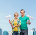 Smiling couple in gloves with paint rollers Royalty Free Stock Photo