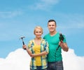 Smiling couple with hammer and drill