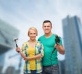 Smiling couple with hammer and drill