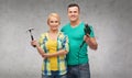 Smiling couple with hammer and drill