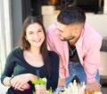 Smiling couple of a happy man an a woman having a drink in a cafÃÂ¨ bar.concept about the joy and fun to spend time together drinki Royalty Free Stock Photo