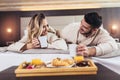 Couple having breakfast in bed in hotel room Royalty Free Stock Photo