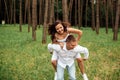 Smiling couple having fun in the park. Love and tenderness, dating, romance, lovers enjoy each other in the summer park