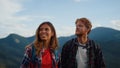 Smiling couple hiking summer mountains closeup. Young travelers explore nature