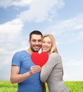 Smiling couple holding big red heart Royalty Free Stock Photo