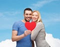 Smiling couple holding big red heart Royalty Free Stock Photo