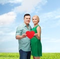 Smiling couple holding big red heart Royalty Free Stock Photo