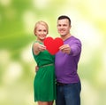 Smiling couple holding big red heart Royalty Free Stock Photo