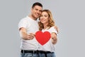 Smiling couple holding big red heart Royalty Free Stock Photo