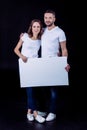 Smiling couple holding blank card Royalty Free Stock Photo