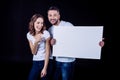 Smiling couple holding blank card Royalty Free Stock Photo