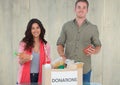 Smiling couple holding eatables from donations box