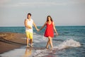 Smiling couple holding hands walking on beach Royalty Free Stock Photo