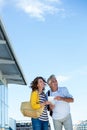 Smiling couple holding map against sky Royalty Free Stock Photo