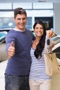 Smiling couple holding their new car key Royalty Free Stock Photo